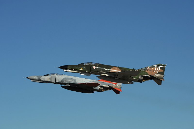 GD DSC_4284.JPG - Two QF-4E Phantom IIs fly in formation after making a low-approach to the runway at Tyndall AFB, FL. on 17 Nov. 2008. Both aircraft are assigned to the 82nd Aerial Targets Squadron (ATRS), 53rd Weapons Evaluation Group (WEG) at Tyndall AFB, FL. The closest aircraft is QF-4E, serial # 72-1478. This aircraft participates in the popular USAF 'Heritage Flight' program and wears a magnificent Southeast Asia paintscheme, full colored sharksmouth and tail markings for the Commander of the 82nd ATRS. The jet is being piloted by the 82nd ATRS Commander, LtC. JD 'Bare' Lee. The second aircraft is QF-4E, serial # 74-1043 and is being piloted by Mr. Tom 'Packer' Mudge. 74-1043 wears unusual two-tone grey marking from its last unit of the 906th Fighter Wing, 704th Fighter Squadron based at Bergstrom AFB, TX. Only a few aircraft assigned to this particular unit were painted in this scheme. Both aircraft hav been returned to service after being modified into drones by BAE Systems in Mojave, CA. The jets continues to serve the AF's needs as full-scale aerial targets and will eventually be destroyed by missiles etc. while being flown by a remote operator on the ground. Photographed on 17 Nov. 2008.  © 2008 Greg L. Davis, Aviation Photojournalist  www.focalplaneimagery.com